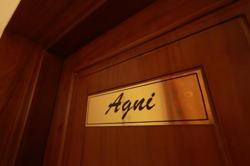 a sign on a wooden wall with the word rent at Tatvaura Resort Wayanad in Padinjarathara
