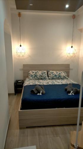 a bedroom with a bed with blue sheets and two pillows at Mattia's house 2 in Bari