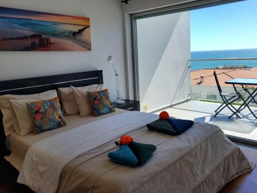 a bedroom with a large bed with two pillows on it at Villa Amazing View - S in Albufeira