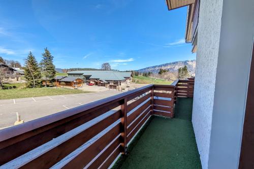 einen Blick vom Balkon eines Hauses mit einem Zaun in der Unterkunft La feclaz - Magnifique appartement 6 personnes in La Feclaz