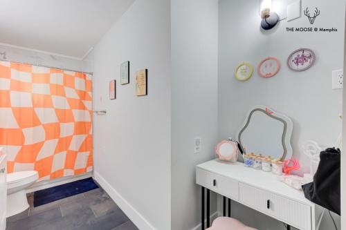 a bathroom with a sink and a toilet and a mirror at The Moose #10 - Stylish Loft with King Bed, Free Parking & Wi-Fi in Memphis