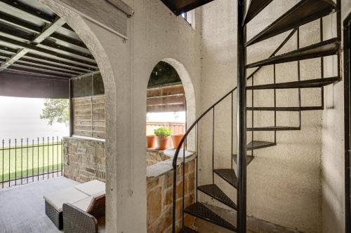 a patio with a spiral staircase in a building at 7 Mi to Winery Lakefront Rockwall Home with Deck in Rockwall
