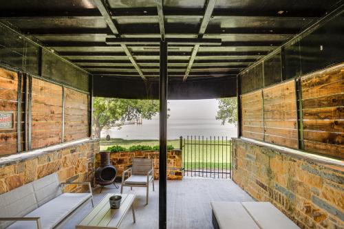 a screened in porch with a table and chairs at 7 Mi to Winery Lakefront Rockwall Home with Deck in Rockwall
