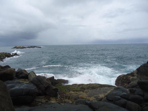 an ocean with waves crashing on the rocks at Santori Unawatuna in Unawatuna