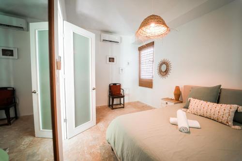 a bedroom with a bed and a room with a window at Boho Oasis by the Beach in San Juan