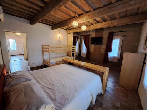 a bedroom with a bed and two bunk beds at B&B Ca Rossa in Cervia