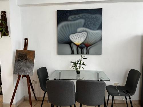 a dining room with a glass table and chairs at Sumaq AirPort in Lima