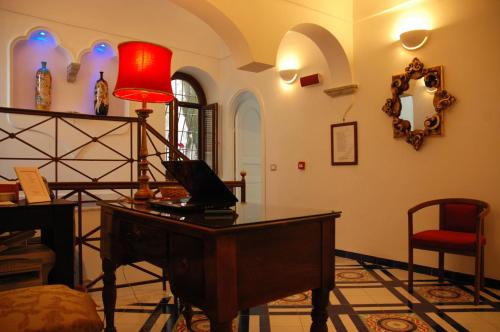 a room with a desk with a laptop on it at Hotel Croce Di Amalfi in Amalfi
