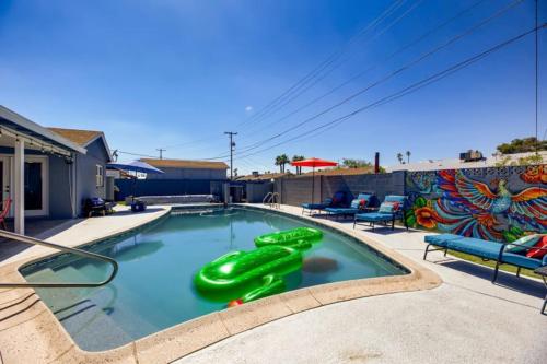 a swimming pool with a green slide in it at Old Town, Single story with Pool,Bunk Beds, and Games in Scottsdale