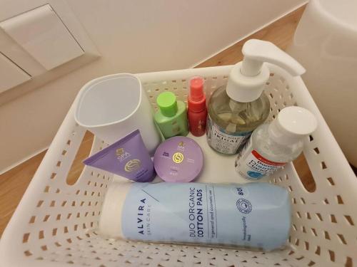 a laundry basket filled with bottles and other items at Apartment near Red Bull Ring in Pirkach