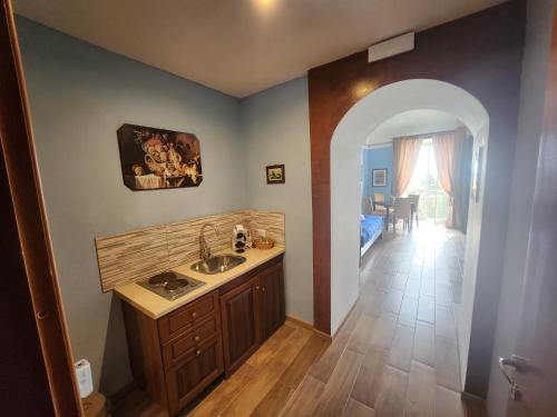 a bathroom with a sink and a hallway with a bedroom at La Pennichella Sorrentina Relais in Meta