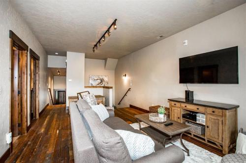 a living room with a couch and a flat screen tv at Cana Loft 302 in Whitefish