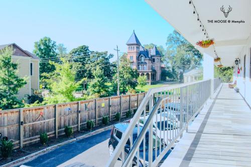 a balcony of a house with a fence and a car at The Moose #11 - Luxe Modern loft with King Bed, Free Parking & Wi-Fi in Memphis