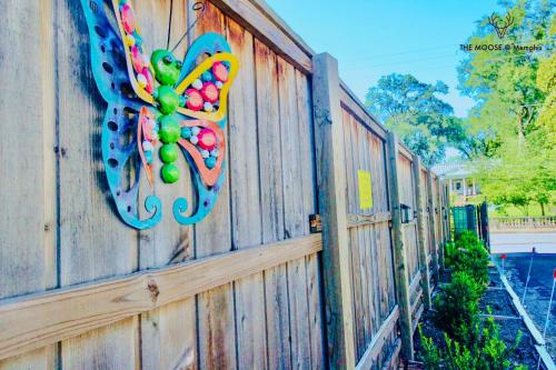 a fence with a colorful butterfly decoration on it at The Moose #11 - Luxe Modern loft with King Bed, Free Parking & Wi-Fi in Memphis