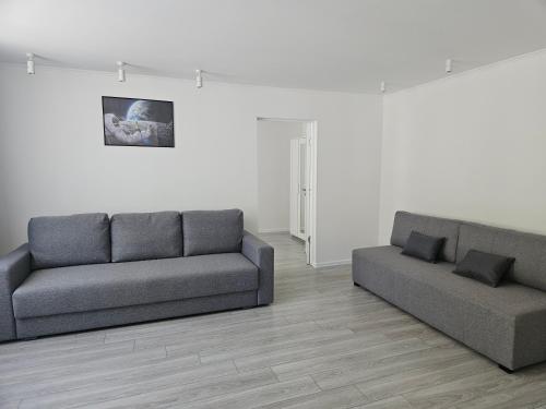 a living room with two couches and a couch at Central Space in Daugavpils