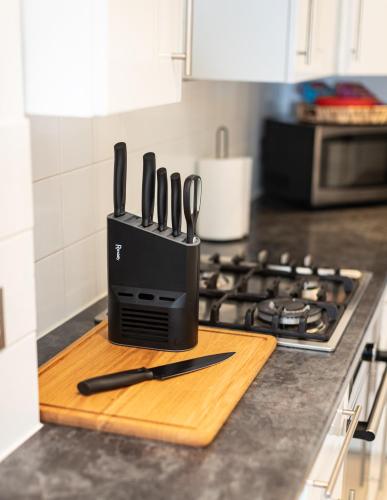 a knife block sitting on top of a kitchen counter at Royal Retreat & Lego Lodge with free parking in Windsor