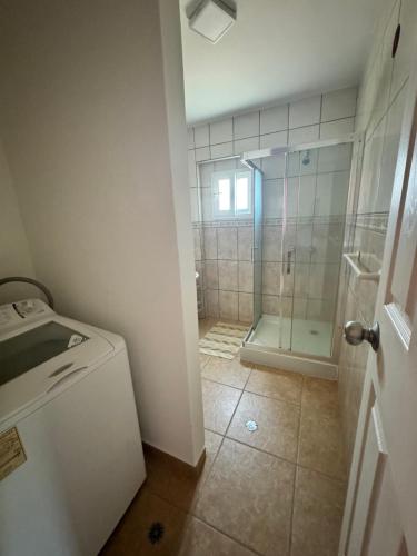 a bathroom with a shower and a glass shower stall at Luxury condominio Tatramar in La Sabana