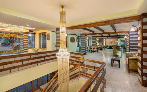 a house with a spiral staircase in a living room at Shobla Royale in Kulu