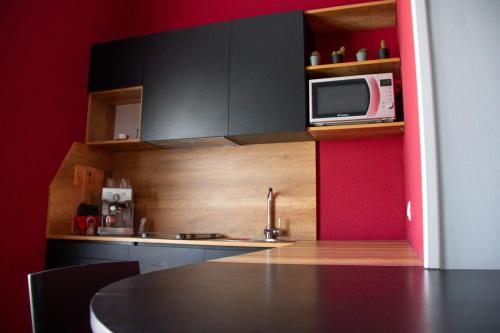 a kitchen with a table and a microwave at B&B LIBRA rooms & suite in Salerno