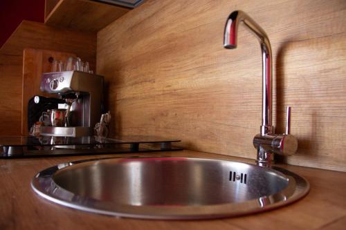 a stainless steel sink in a kitchen with a coffee maker at B&B LIBRA rooms & suite in Salerno