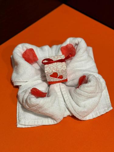 a white towel with a box on top of it at Hotel Spa Pinar del Mar in Platja  d'Aro
