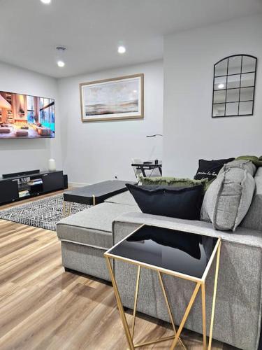 a living room with a couch and a table at Cozy 2 bedrooms and 1 bath for 4 guests! in Calgary