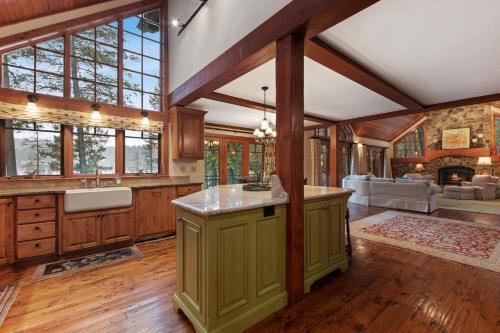 an open kitchen with wooden cabinets and a fireplace at Lake View Escape in Whitefish