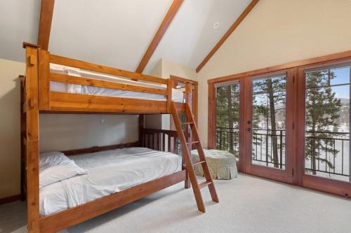 a bedroom with a bunk bed and a balcony at Lake View Escape in Whitefish
