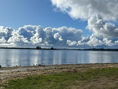 a large body of water with clouds in the sky at Cabañas Casatur para 6 personas en Ancud Chiloe in Ancud