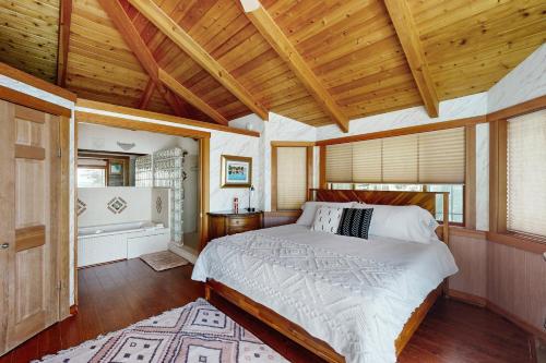a bedroom with a bed in a room with wooden ceilings at Horizon's End in Islandale