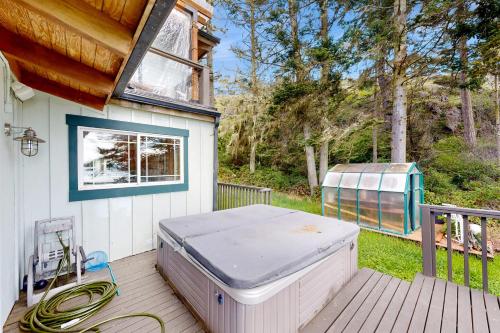 a hot tub sitting on the deck of a house at Horizon's End in Islandale