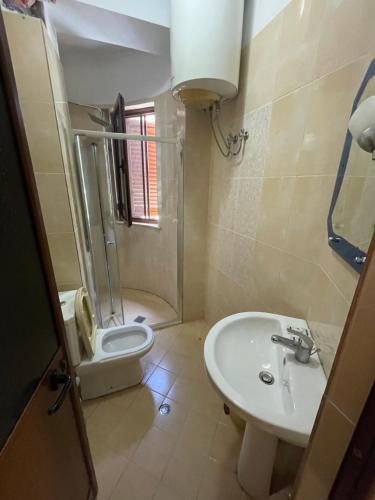 a bathroom with a sink and a toilet and a shower at Hotel Freedom in Lezhë
