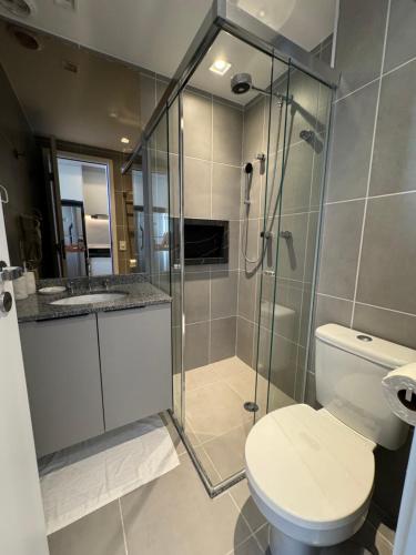 a bathroom with a toilet and a glass shower at 915 Lux Studio Allianz Park in Sao Paulo