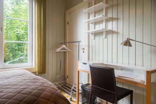 a bedroom with a desk and a bed at Kollen Slottet in Oslo