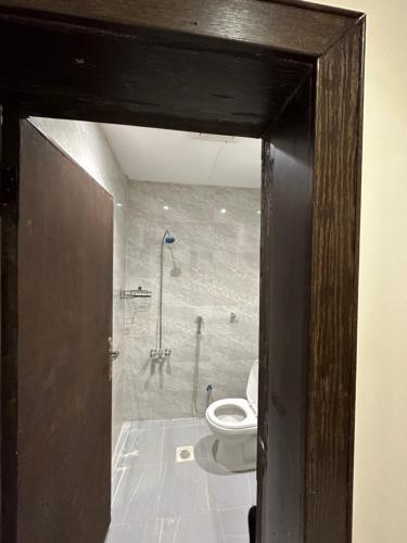 a bathroom with a toilet and a shower at شقة في حي المغرزات in Riyadh