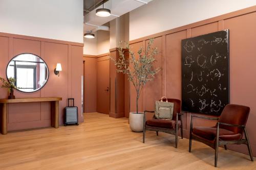 a waiting room with two chairs and a chalkboard at Sonder Market Hall in Chicago