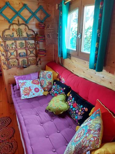 a bean bag couch in a room with pillows at La roulotte de Mouni in Gesves