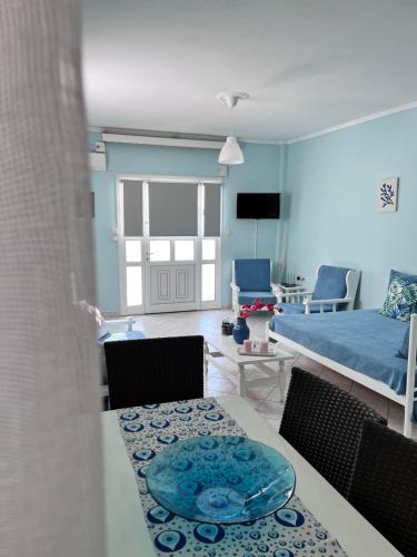 a living room with a table and a bed at Zoel's House in Chalkidiki in Agia Paraskevi