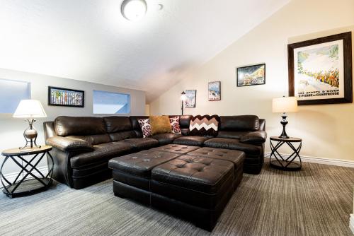 a living room with a leather couch and a table at Luxury Condo Steps to Park City Mountain Resort! Heated Pool & Hot Tub -Snowblaze 309 in Park City