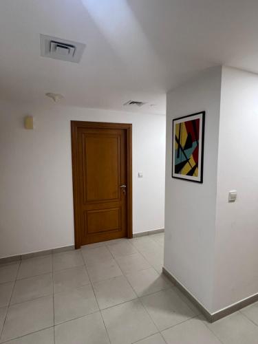 a room with a door and a picture on the wall at Dubai Entire Serviced Room Unit Excellence in Dubai