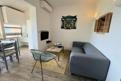 un salon avec un canapé et une table dans l'établissement Charming 37 m nest near the sea, à Ajaccio