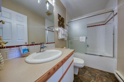 a white bathroom with a sink and a toilet at Marble Canyon in Fairmont Hot Springs