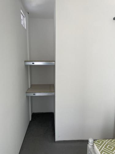 an empty closet with a white refrigerator in a room at Ancestral Casa de Campo in Roldanillo