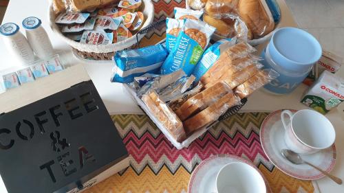 a counter top with a table with food and a book at Bellavista panoramic terrace Appartamento con terrazza zona Sant Orsola in Bologna