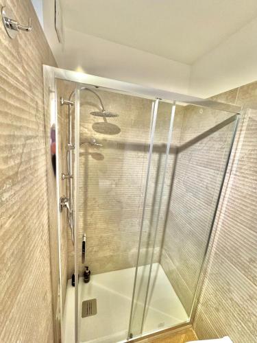 a shower with a glass door in a bathroom at Bari annette room in Bari