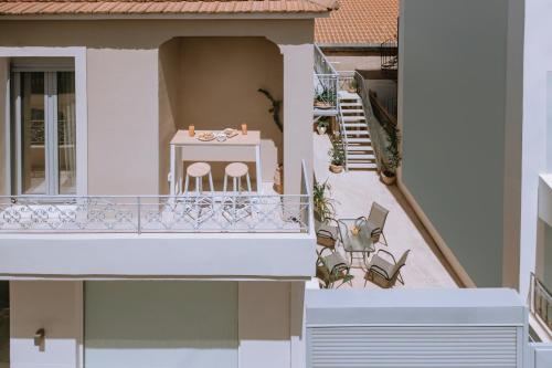 a balcony of a house with a table and chairs at CentroCitta Luxury House in Argostoli