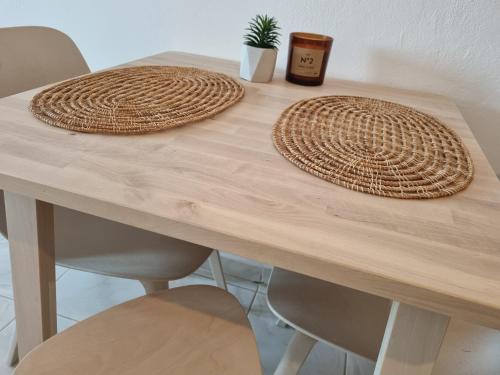 a wooden table with two baskets on top of it at Tolo at sea - Nova in Tolo