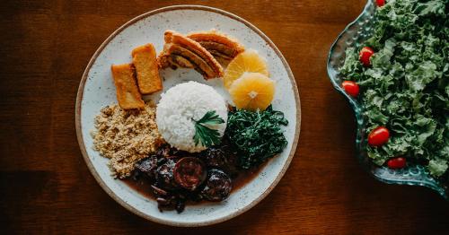 a plate of food with rice and vegetables on a table at Paraty Hotel Fazenda & Spa in Ibiúna