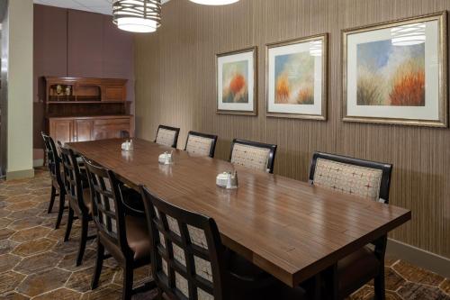 a conference room with a large wooden table and chairs at DoubleTree by Hilton Kansas City - Overland Park in Overland Park