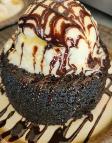 a chocolate cake with whipped cream and chocolate sauce at La Jamaca - An Island Vibe Hotel in La Parguera